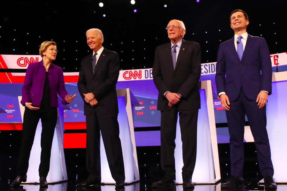 Elizabeth Warren, Joe Biden, Bernie Sanders and Pete Buttigieg take the stage before the Democratic primary debate in Des Moines on Tuesday. (Photo by Spencer Platt/Getty Images)