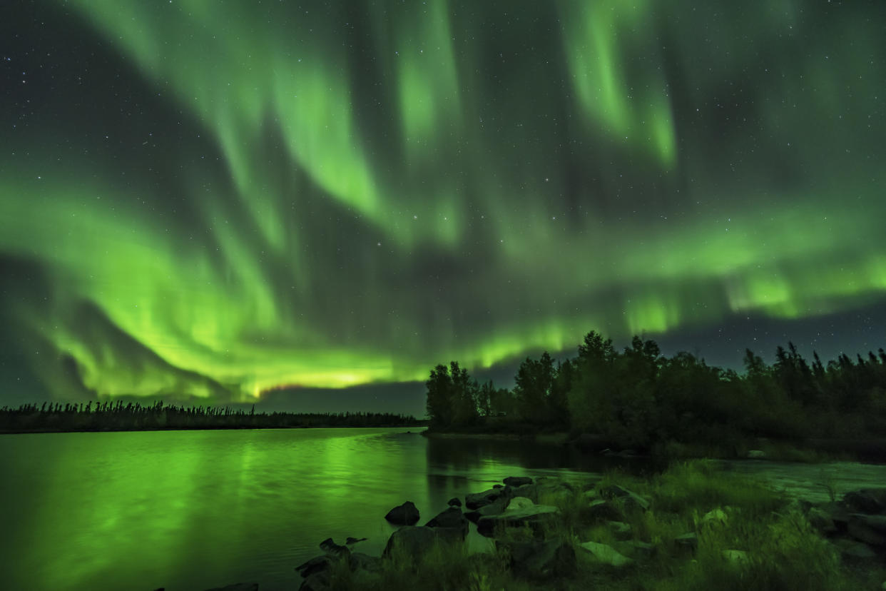 A bright sky-filling aurora at Tibbitt Lake on the Ingraham Trail east of Yellowknife, NWT. (Photo by: VW Pics/Universal Images Group via Getty Images)