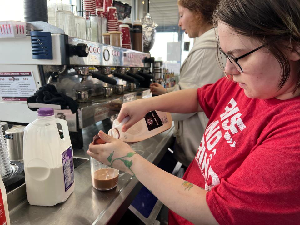 Employees make coffee for customers inside the 7 Brew building location in Flowood.