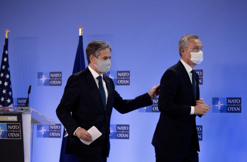 U.S. Secretary of State Antony Blinken, left, puts his hand on the back of NATO Secretary General Jens Stoltenberg after addressing a media conference prior to a meeting of NATO foreign ministers at NATO headquarters in Brussels on Tuesday, March 23, 2021. (AP Photo/Virginia Mayo, Pool)