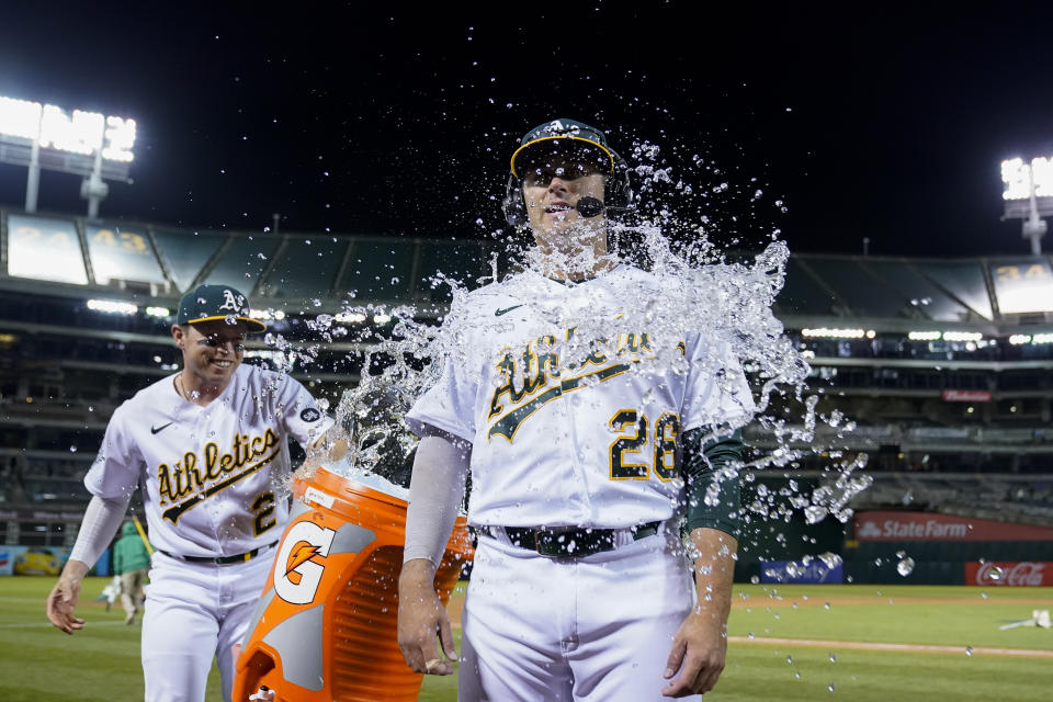 Oakland Athletics' Nick Allen, left, douses Jonah Bride with iced water after the team's 2-1 victory over the Atlanta Braves in a baseball game in Oakland, Calif., Tuesday, May 30, 2023. (AP Photo/Godofredo A. Vásquez)