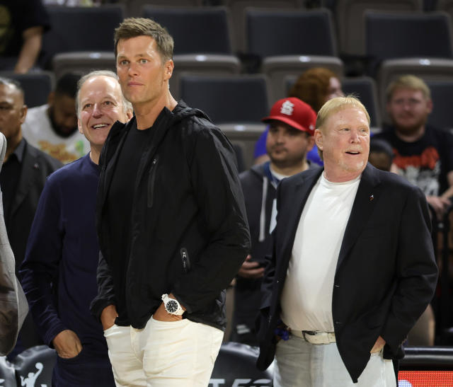 LAS VEGAS, NEVADA - MAY 31: (L-R) Sportscaster Jim Gray, Tampa Bay Buccaneers quarterback Tom Brady and Las Vegas Raiders owner and managing general partner and Las Vegas Aces owner Mark Davis watch players warm up during halftime of a game between the Connecticut Sun and the Aces at Michelob ULTRA Arena on May 31, 2022 in Las Vegas, Nevada. The Aces defeated the Sun 89-81. NOTE TO USER: User expressly acknowledges and agrees that, by downloading and or using this photograph, User is consenting to the terms and conditions of the Getty Images License Agreement. (Photo by Ethan Miller/Getty Images)