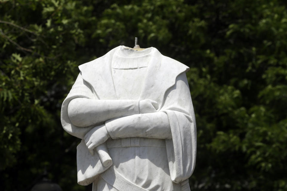 FILE - In this file photo dated Wednesday, June 10, 2020, a damaged Christopher Columbus statue stands in a waterfront park near the city's traditionally Italian North End neighborhood, in Boston, USA., after the statue was found beheaded Wednesday morning. Statues of the 15th-century explorer and the Spanish conquistadors who followed him and colonized much of the Americas have not become targets for demonstrators in Spain and USA. The death of George Floyd at the hands of police and Minneapolis, USA, has sparked a re-examination of injustices and inequalities in the fabric of many societies, often symbolized in statues of historical figures have become the focus of protest around the world. (AP Photo/Steven Senne, FILE)