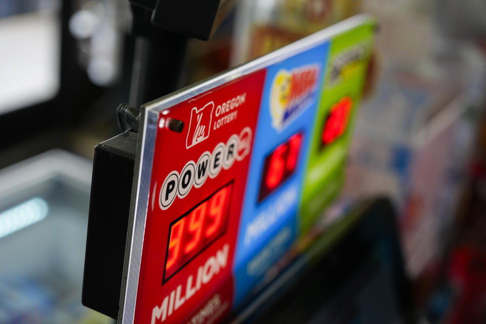 A sign for the Powerball jackpot is displayed at a 7-Eleven, Friday, April 5, 2024, in Portland, Ore. (AP Photo/Jenny Kane)