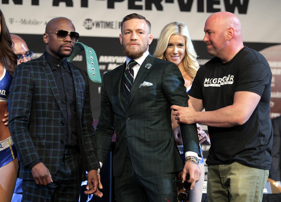 Dana White, far right, with Floyd Mayweather and Conor McGregor during their boxing promotion. (Getty)