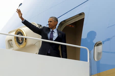 U.S. President Barack Obama waves as he boards Air Force One to travel to Jamaica from Joint Base Andrews, Maryland, April 8, 2015. REUTERS/Jonathan Ernst