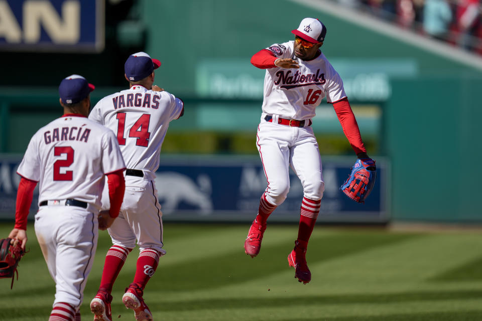 Washington Nationals' Victor Robles (16) celebrates with Luis Garcia and Ildemaro Vargas after a baseball game against the Atlanta Braves at Nationals Park, Sunday, April 2, 2023, in Washington. The Nationals won 4-1. (AP Photo/Alex Brandon)