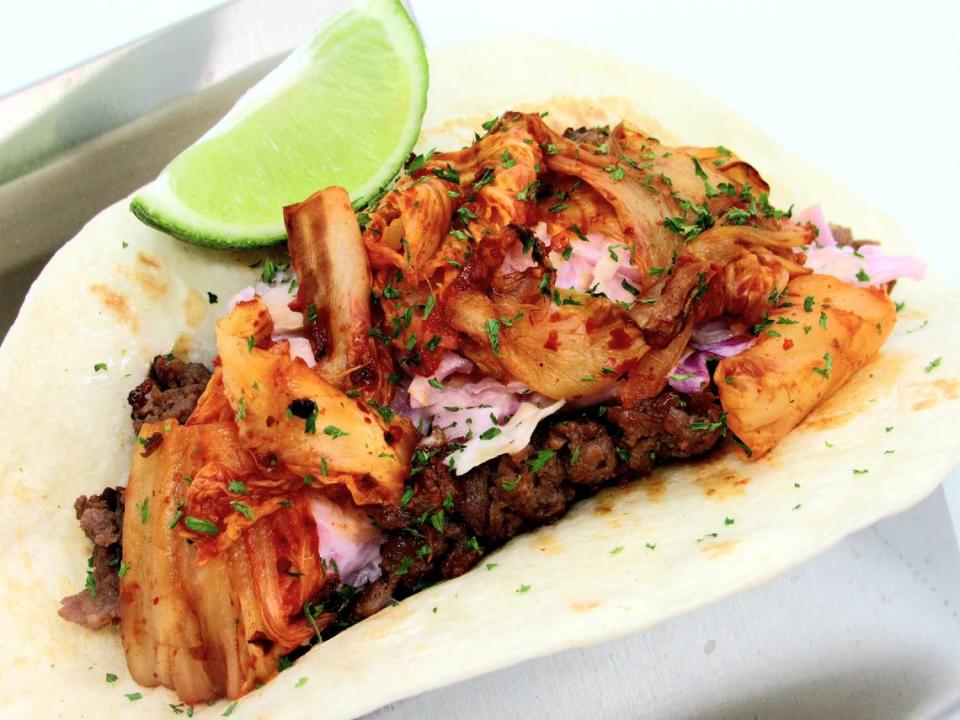 This Beef Bulgogi Kimchi Taco offered on the Taco Park menu at Park’s Food St. is a Korean twist on a taco. It includes Korean beef bulgogi, grilled kimchi, garlic sauce, parsley, and lime. 