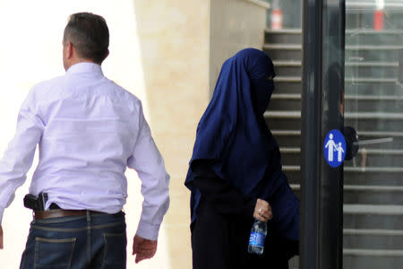 A woman repatriated to Kosovo from Syria enters the Basic Court in Pristina, Kosovo, April 23, 2019. REUTERS/Laura Hasani