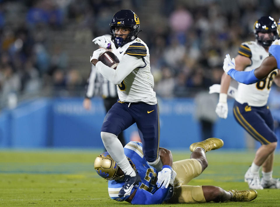 California wide receiver Taj Davis is tackled by UCLA defensive lineman Grayson Murphy during the first half of an NCAA college football game Saturday, Nov. 25, 2023, in Pasadena, Calif. (AP Photo/Ryan Sun)