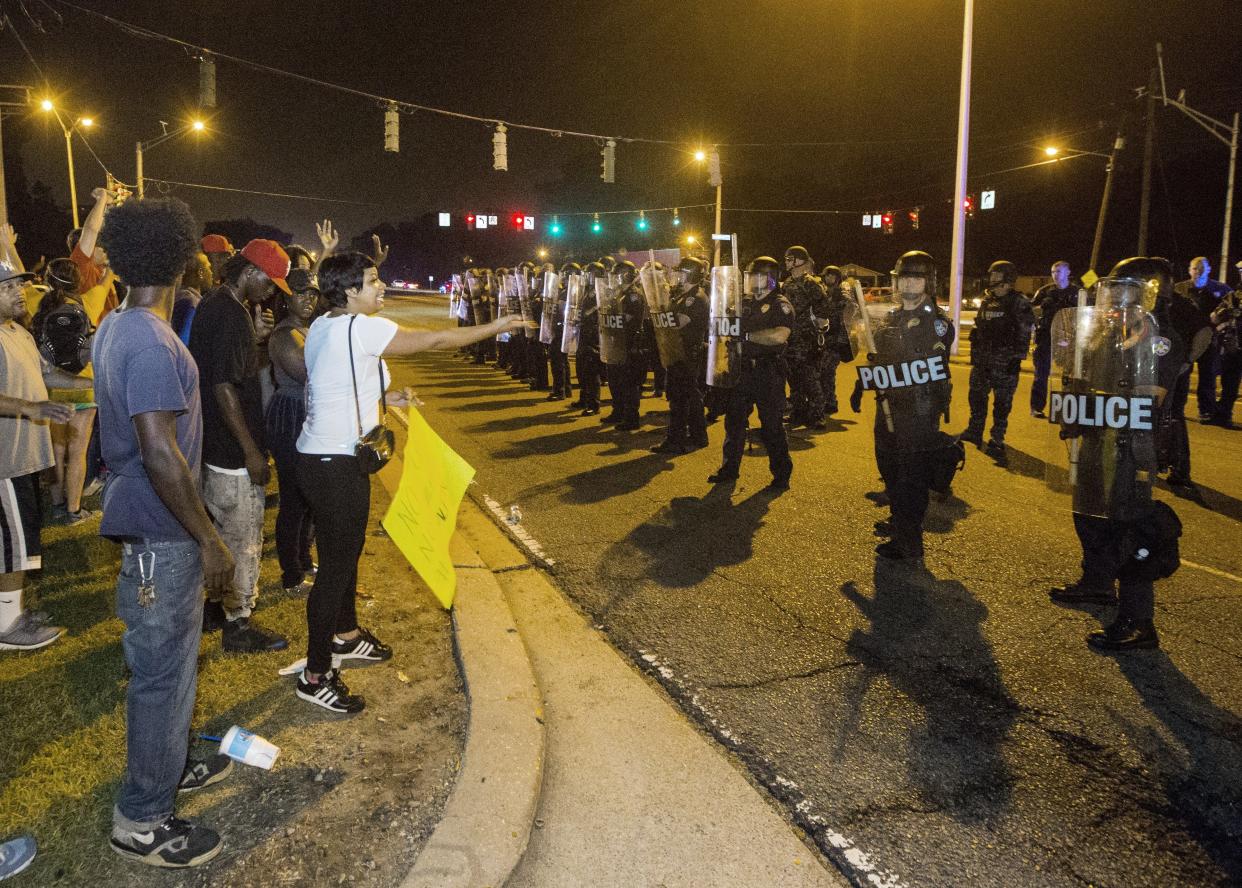 BATON ROUGE, LA -JULY 10: People gather to protest against the shooting of Alton Sterling on July 10, 2016 in Baton Rouge, Louisiana. Alton Sterling was shot by a police officer in front of the Triple S Food Mart in Baton Rouge on July 5th, leading the Department of Justice to open a civil rights investigation. (Photo by Mark Wallheiser/Getty Images)