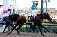 May 2, 2015; Louisville, KY, USA; Victor Espinoza aboard American Pharoah celebrates winning the 141st Kentucky Derby at Churchill Downs. Mandatory Credit: Peter Casey-USA TODAY Sports