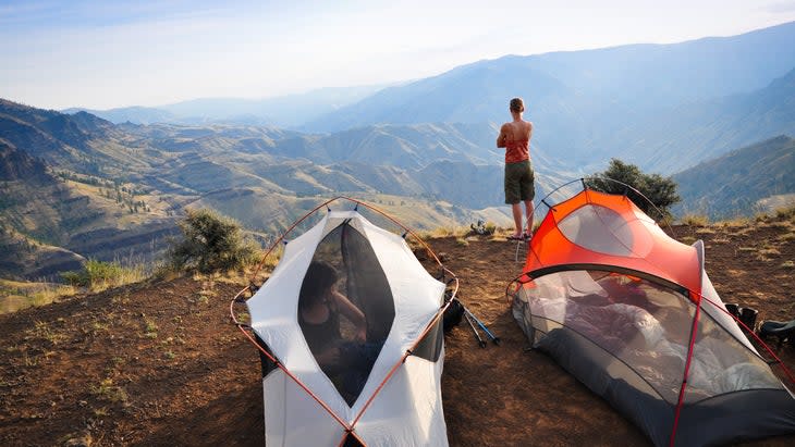 <span class="article__caption">A backpacker admires the view across Hells Canyon from her campsite.</span> (Photo: thinair28/Getty)