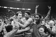 FILE - Philadelphia 76ers Bobby Jones, left, embraces Julius Erving after 76ers defeated the Los Angeles Lakers in four straight games to win the NBA Championship, May 31, 1983. (AP Photo, File)