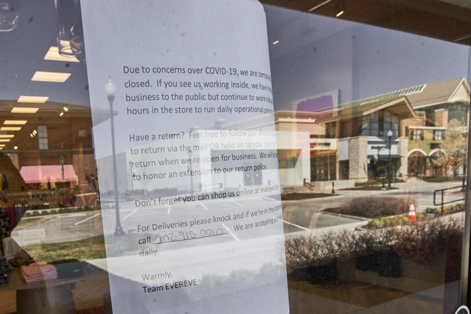 Shuttered stores at the Village Pointe shopping mall are reflected in Omaha, Neb., Wednesday, April 15, 2020. U.S. retail sales plummeted 8.7% in March as the coronavirus outbreak forced an almost complete lockdown of commerce. (AP Photo/Nati Harnik)