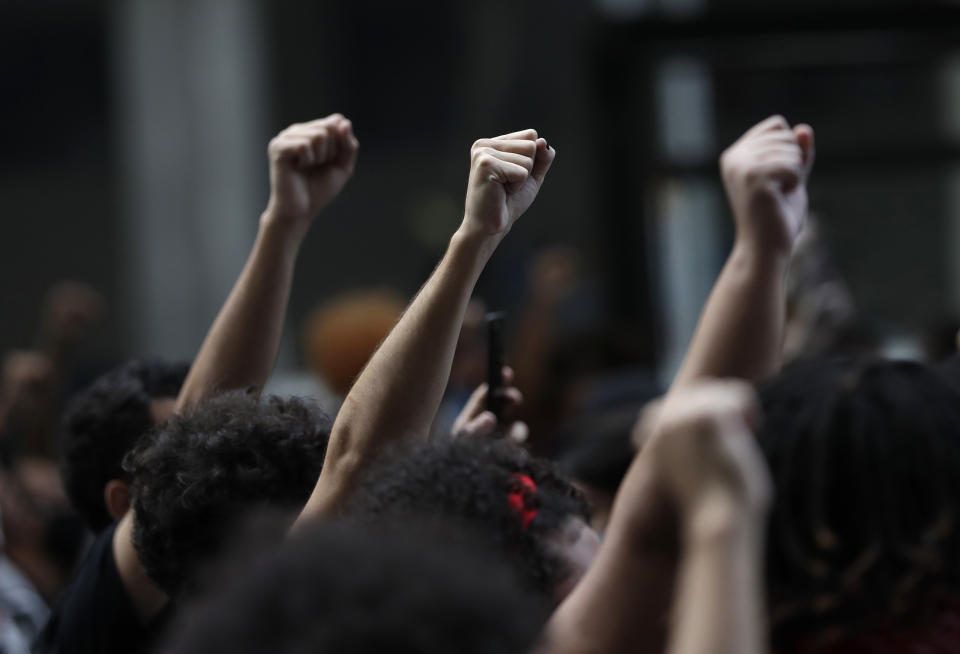 FILE - In this June 7, 2020 file photo, people protest against racism and hate crimes during a Black Lives Matter demonstration in Rio de Janeiro, Brazil. These protests are nowhere near the size and public impact of other countries, a fact demonstrators blame on Brazilians' continued complacence on the streets and the halls of political power. (AP Photo/Silvia Izquierdo, File)