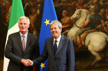 European Union's chief Brexit negotiator Michel Barnier (L) shakes hand with Italy's Prime Minister Paolo Gentiloni during a meeting in Rome, Italy September 21, 2017. REUTERS/Alessandro Bianchi