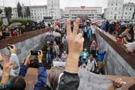 Protesters gather in front of the Minsk Tractor Works Plant to support workers leaving the plant after their work shift in Minsk, Belarus, Wednesday, Aug. 19, 2020. Belarus President Alexander Lukashenko repeatedly rejected demands to step down and bristled at the idea of talks with the opposition, denouncing the coordination council on Tuesday as a "an attempt to seize power" in the country. Nevertheless, the council is set to convene for the first time Wednesday. (AP Photo/Dmitri Lovetsky)