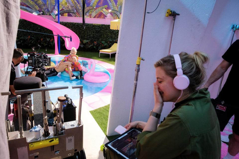 Greta Gerwig directing a scene in Barbie