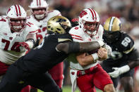 FILE - Wisconsin quarterback Tanner Mordecai (8) is tackled by Purdue linebacker Nic Scourton (5) during the first half of an NCAA college football game in West Lafayette, Ind., Friday, Sept. 22, 2023. Scourton could make a big impact after transferring from Purdue to Texas A&M. The 6-foot-4, 280-pounder had 50 tackles for the Boilermakers last season, including 15 tackles for loss and 10 sacks. (AP Photo/Michael Conroy, File)