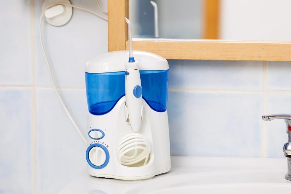 water flosser on sink counter