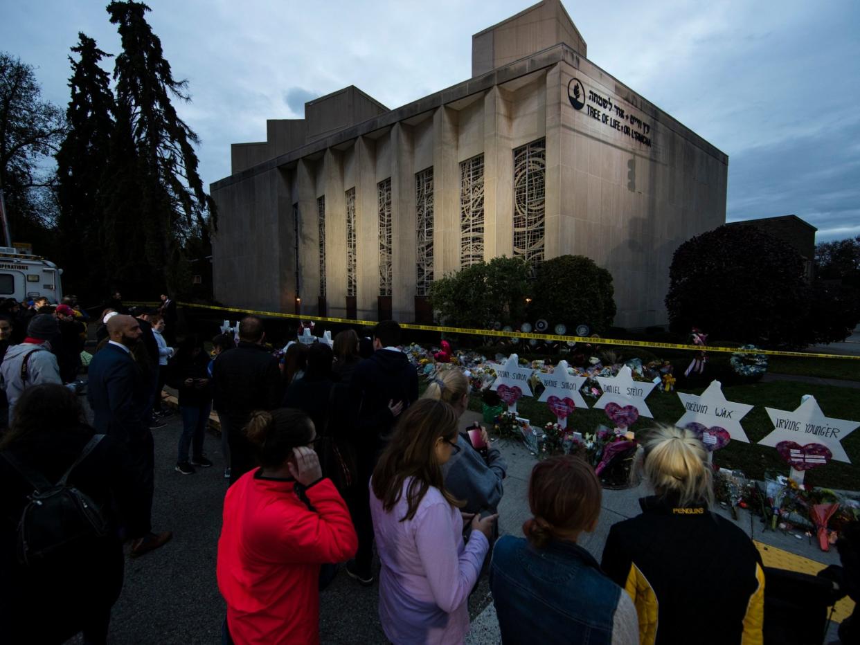 People pay their respects at a makeshift memorial in the aftermath of a deadly shooting at the Tree of Life Synagogue in Pittsburgh: AP