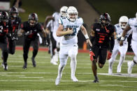 Coastal Carolina quarterback Bryce Carpenter (12) breaks away from Arkansas State defender Leon Jones (2) as he runs for a touchdown during the first half of an NCAA college football game Thursday, Oct. 7, 2021, in Jonesboro, Ark. (AP Photo/Michael Woods)