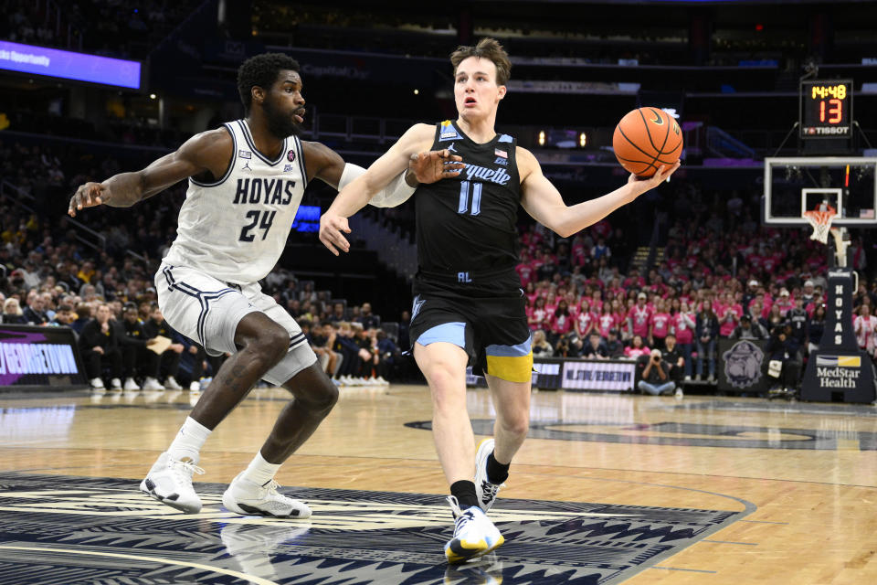 Marquette guard Tyler Kolek (11) goes to the basket against Georgetown forward Supreme Cook (24) during the first half of an NCAA college basketball game, Saturday, Feb. 3, 2024, in Washington. (AP Photo/Nick Wass)