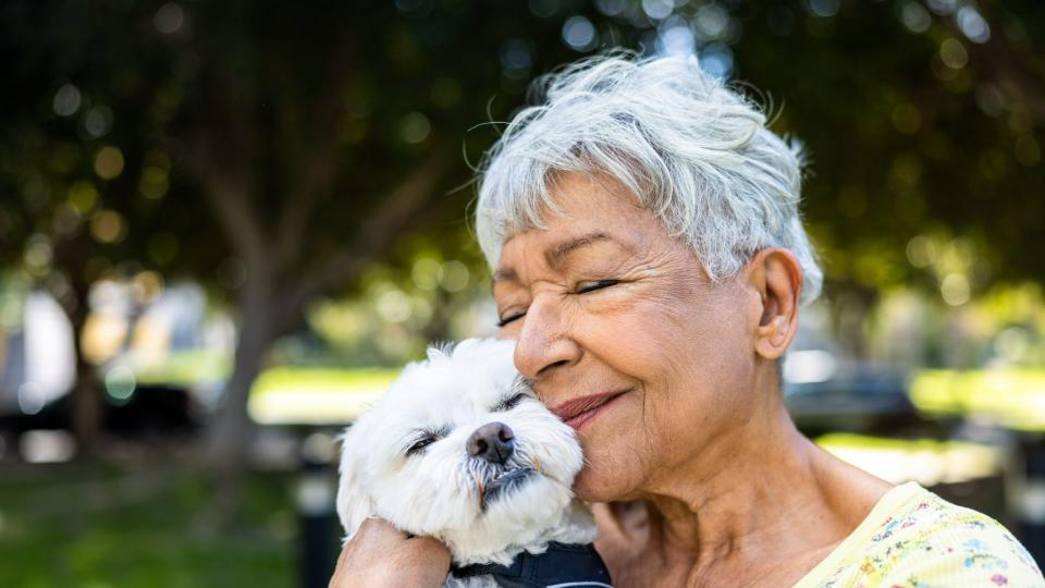 Woman snuggling dog