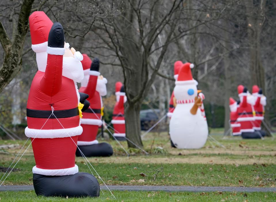 A Dec. 21, 2023, photo shows some of the more than two dozen Santa Claus inflatables being displayed by residents of North Stanwood Road in Bexley, dubbed "Santawood" for the holidays.  The displays were still up as of Wednesday afternoon, Jan. 3, 2024.