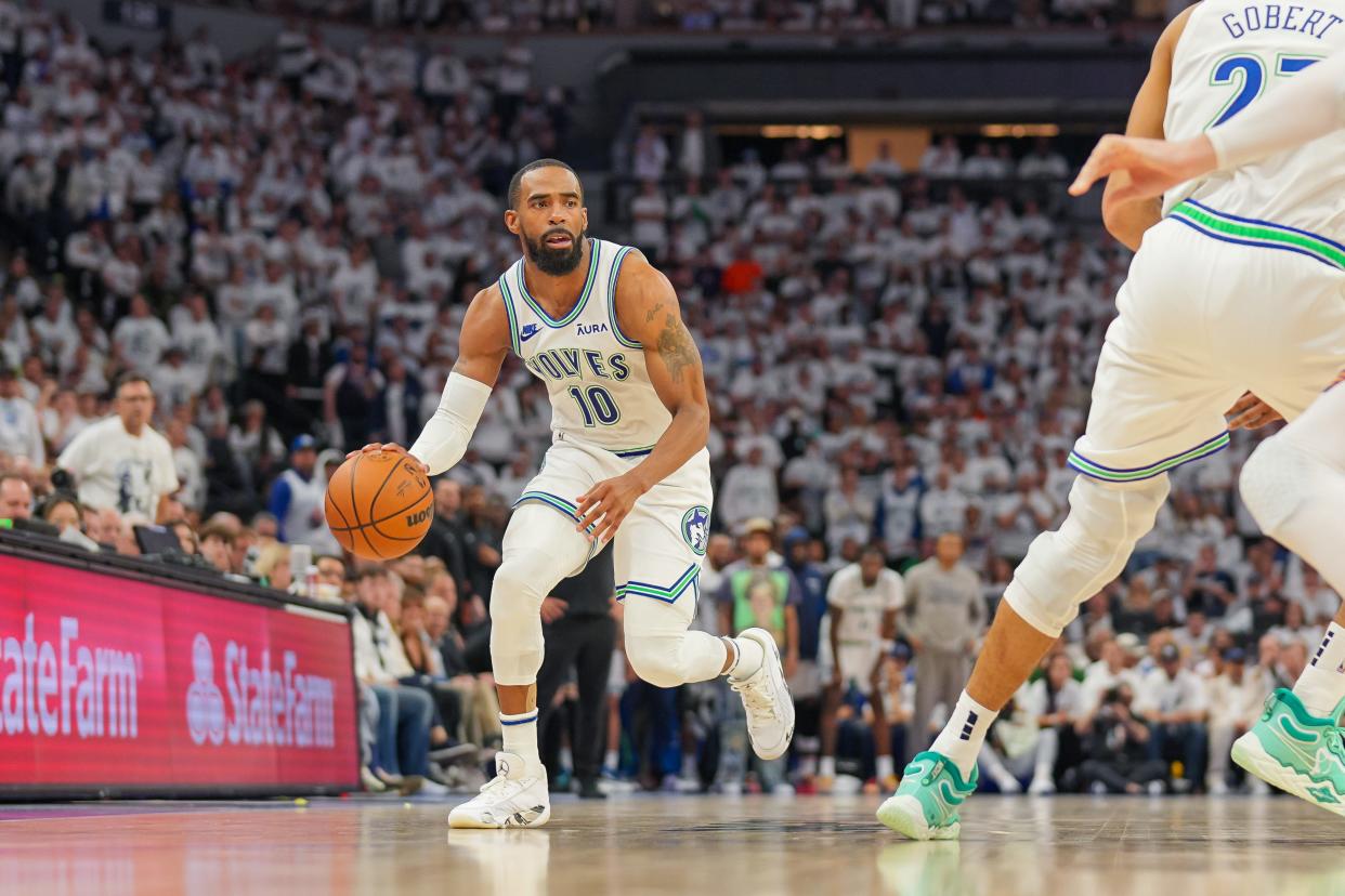 Apr 23, 2024; Minneapolis, Minnesota, USA; Minnesota Timberwolves guard Mike Conley (10) dribbles against the Phoenix Suns in the fourth quarter during game two of the first round for the 2024 NBA playoffs at Target Center. Mandatory Credit: Brad Rempel-USA TODAY Sports