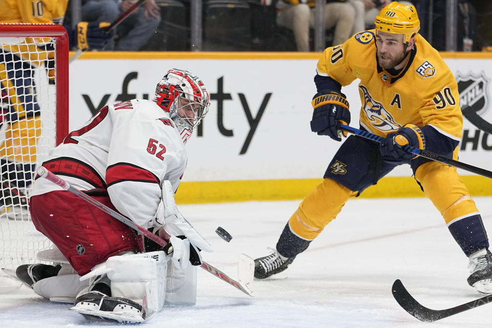 Carolina Hurricanes goaltender Pyotr Kochetkov (52) blocks a shot on goal by Nashville Predators center Ryan O'Reilly (90) during the second period of an NHL hockey game Wednesday, Dec. 27, 2023, in Nashville, Tenn. (AP Photo/George Walker IV)