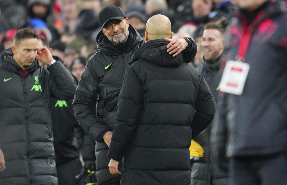 Liverpool's manager Jurgen Klopp, left, hugs Manchester City's head coach Pep Guardiola after the English Premier League soccer match between Liverpool and Manchester City, at Anfield stadium in Liverpool, England, Sunday, March 10, 2024. The match ended 1-1. (AP Photo/Jon Super)