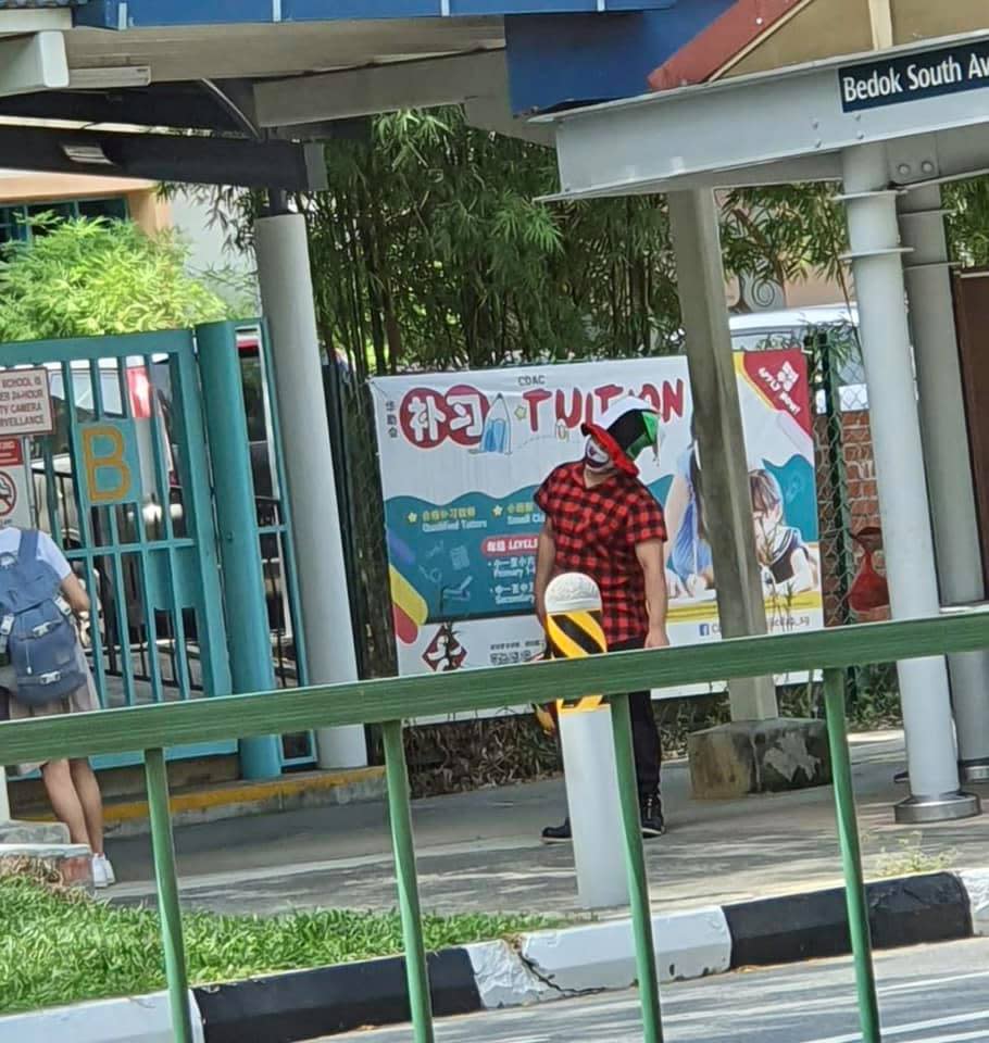 A photo of a clown waiting outside a school that has been circulating on social media. (PHOTO: Facebook / Tan Chuan-Jin)