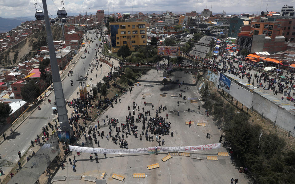 Supporters of Bolivian President Evo Morales block a road that connects La Paz and El Alto, to show their support of his apparent reelection in El Alto, Bolivia, Sunday, Nov. 10, 2019. President Morales is calling for new presidential elections and an overhaul of the electoral system Sunday after a preliminary report by the Organization of American States found irregularities in the Oct. 20 elections. (AP Photo/Juan Karita)