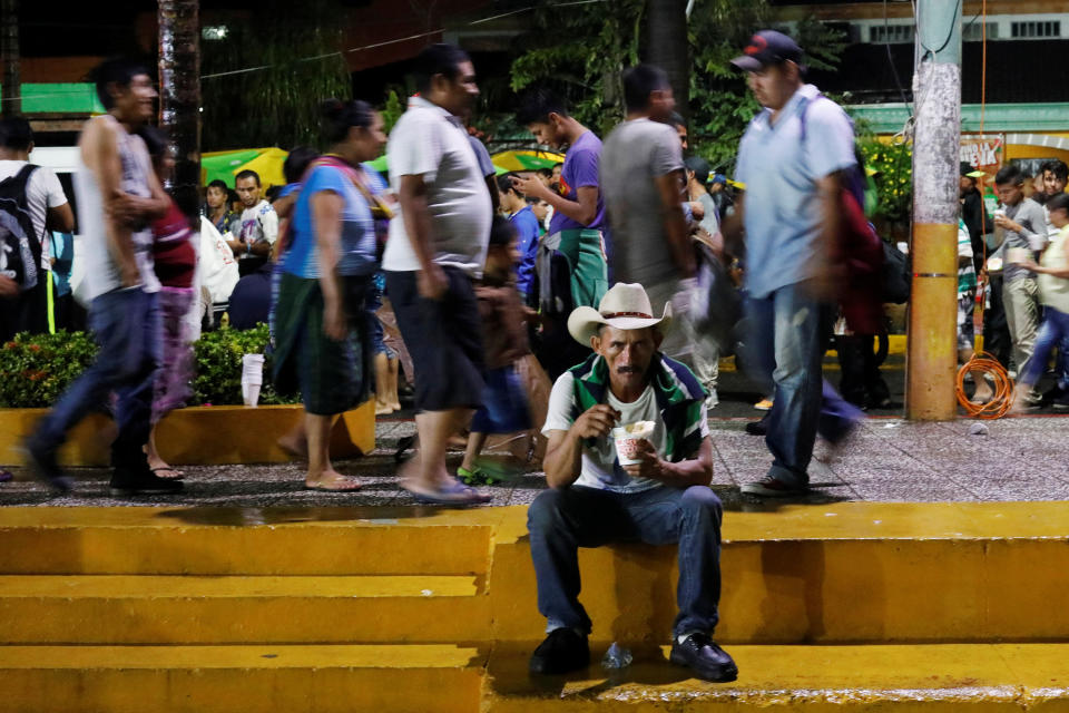 A Honduran migrant drinks soup during a new leg of their travel in Tecun Uman, Guatemala, on Oct. 18, 2018.