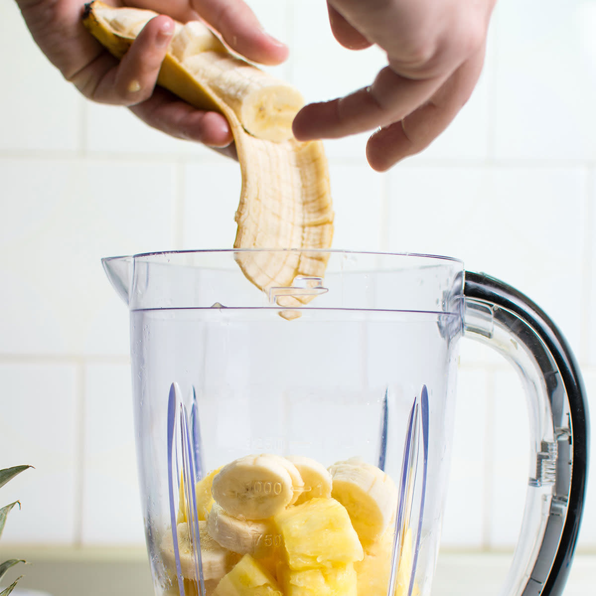 a blender with pineapple and banana