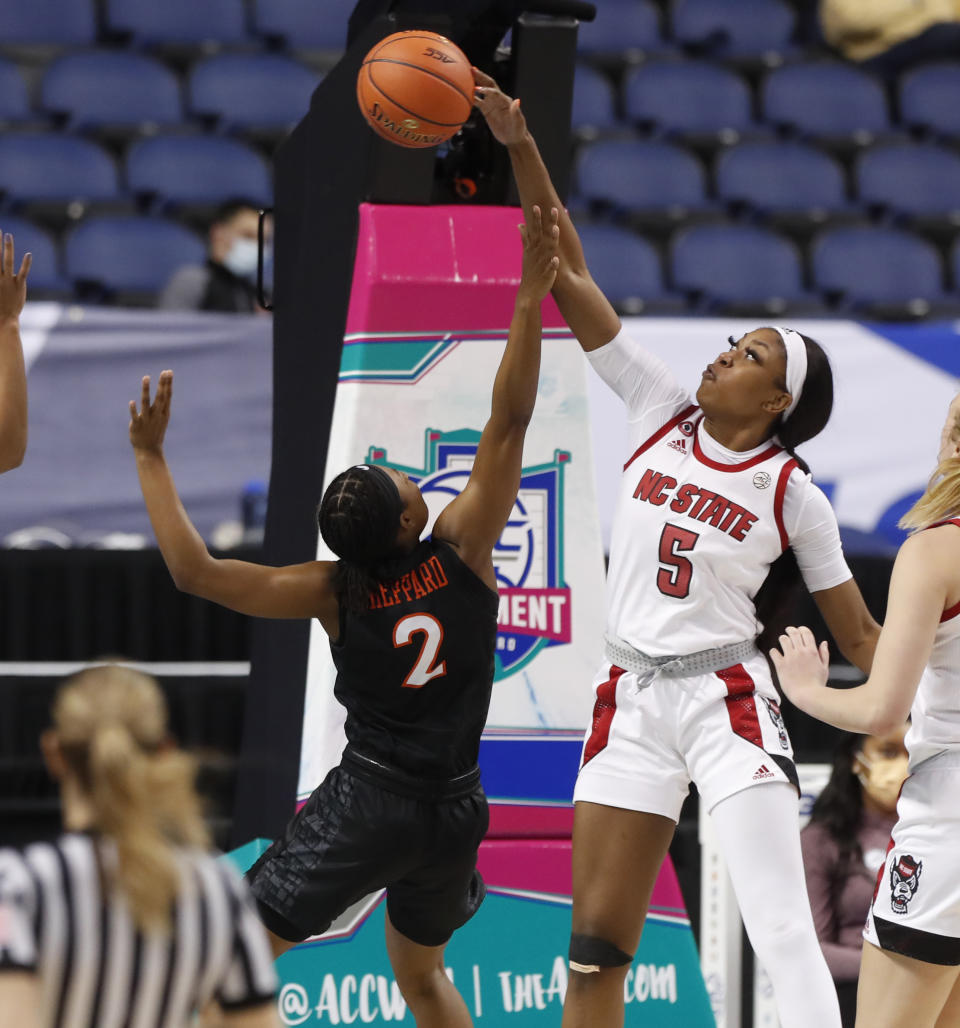 North Carolina State's Jada Boyd (5) blocks the shot by Virginia Tech's Aisha Sheppard (2) during the second half of an NCAA college basketball game in the quarterfinals of the Atlantic Coast Conference women's tournament Friday, March 5, 2021, in Greensboro, N.C. (Ethan Hyman/The News & Observer via AP)