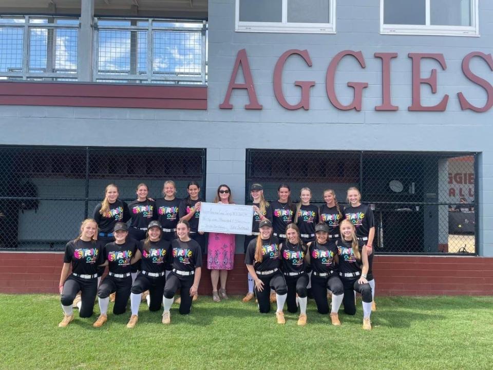 The Tate softball team presented a $31,000 check to the American Cancer Society.