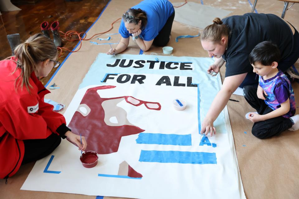 Volunteers paint a a portrait of Lloyd Barbee, at the Lloyd Barbee Montessori School on Monday, January 15, 2024. In honor of Dr. Martin Luther King, over 250 volunteers came to paint fresh murals as the school in Milwaukee, Wisconsin.
