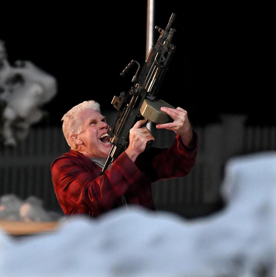 Actor Ron Perlman ("Sons of Anarchy," "Hellboy,") fires an automatic weapon into the sky while filming a night time scene for the Netflix Comedy "Don't Look Up," on Simpson Drive in Framingham, Feb. 3, 2021.   Perlman plays Colonel Ben Drask in the film.  