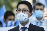 Hong Kong activist Nathan Law takes part in a protest during the visit of Chinese Foreign Minister Wang Yi in Berlin, Germany, Tuesday, Sept. 1, 2020. German Foreign Minister Heiko Maas meets his Chinese counterpart at the foreign ministry guest house Villa Borsig for bilateral talks. (AP Photo/Markus Schreiber)