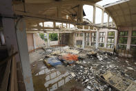 General view of the ruins of the sports complex of the National Technical University in Kharkiv, Ukraine, Friday, June 24, 2022, damaged during a night shelling. The building received significant damage. A fire broke out in one part but firefighters managed to put it out. (AP Photo/Andrii Marienko)