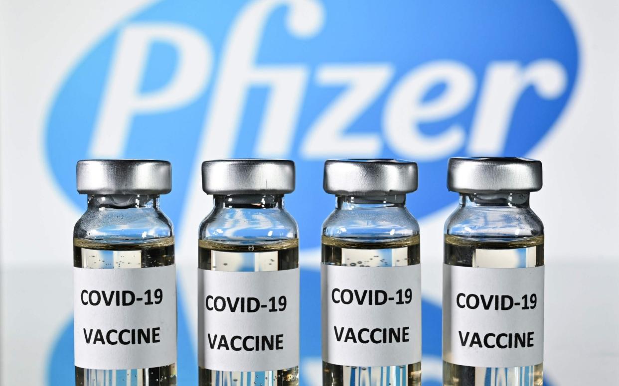 Illustration picture shows vials with Covid-19 Vaccine stickers attached - JUSTIN TALLIS/AFP via Getty Images