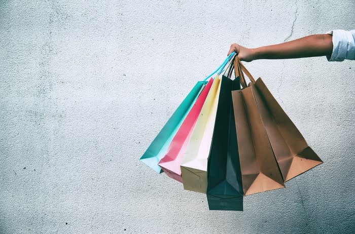 Woman holding multiple shopping bags.