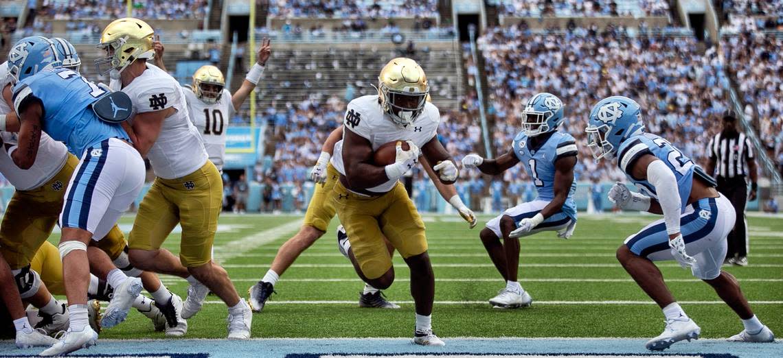 Notre Dame’s Audric Estime (7) scores on a one-yard run to give the Irish a 21-14 lead over North Carolina in the second quarter on Saturday, September 24, 2022 at Kenan Stadium in Chapel Hill, N.C.