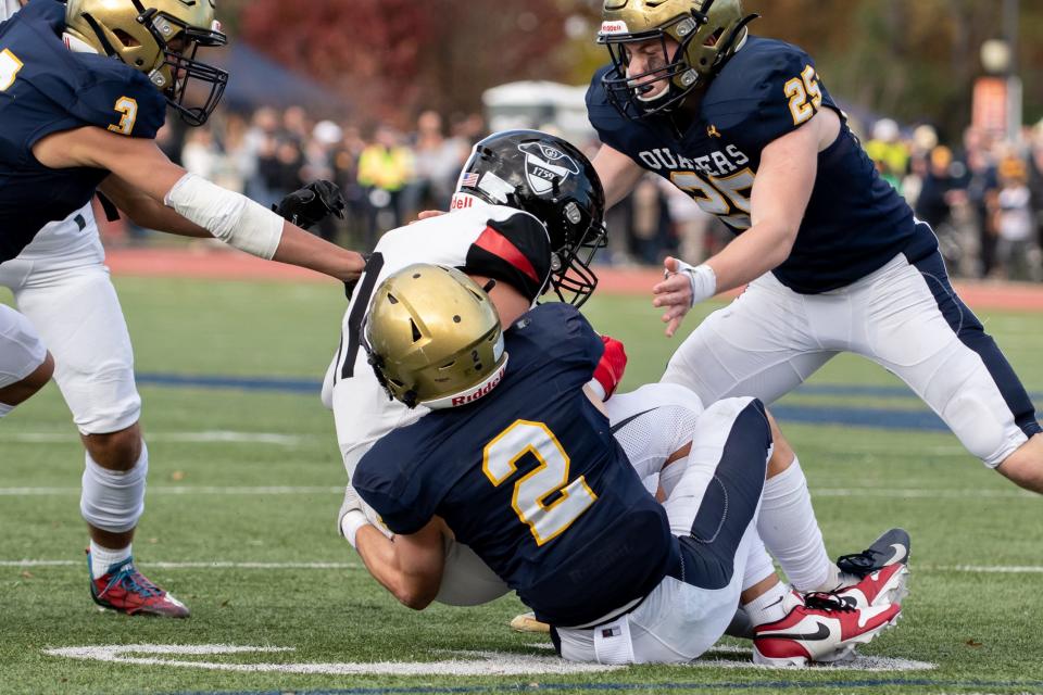 Germantown Academy wide receiver A.J. Towsen is brought down by Penn Charter's Eain Kilpatrick during Saturday's game.