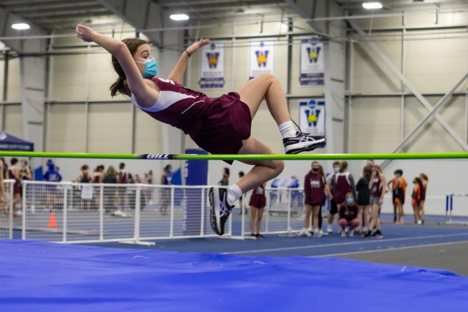 Bishop Stang’s Elizabeth Jones jumps the bar on Thursday at Wheaton College. 