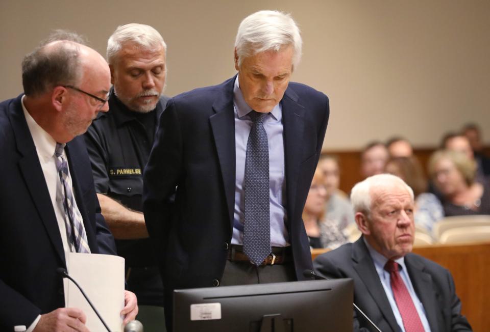 James Krauseneck Jr., standing at center, is taken back into custody by Monroe County Sheriff's deputies following his sentencing for the 1982 homicide of his wife, Monday, Nov. 7, 2022 at the Hall of Justice in Rochester.  Krauseneck Jr. was sentenced to 25 years to life in prison.