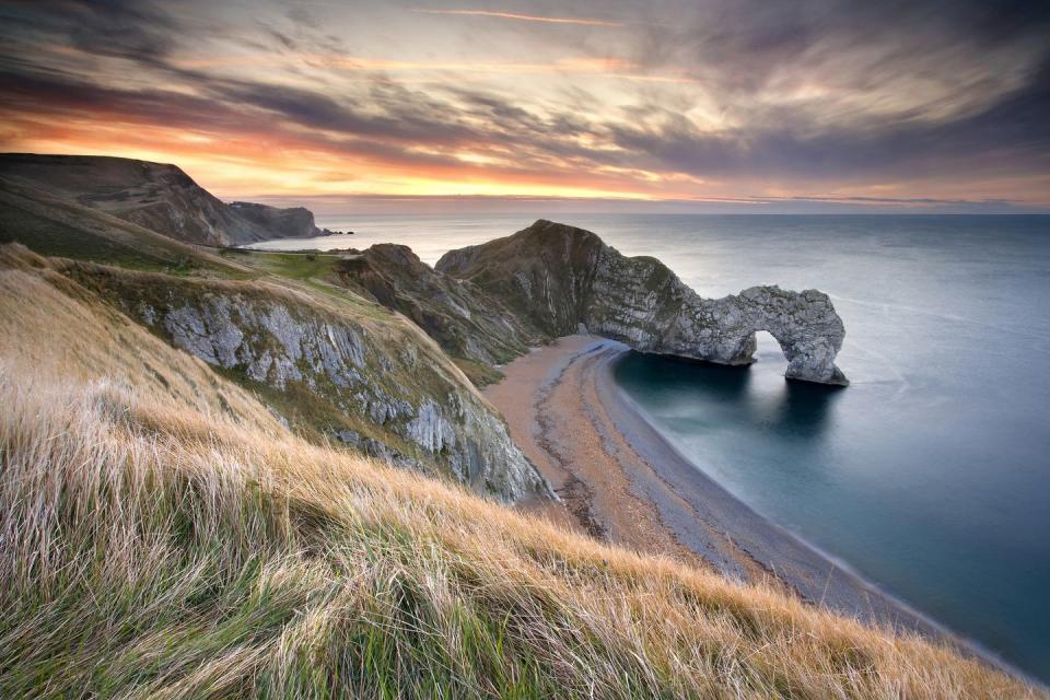 <p>Around 10,000 years ago, water broke through a stack of rocks on the Jurassic Coast and started to create one of the most incredible formations in the UK. Today, Durdle Door is an iconic archway with a sandy beach that you'll find on many postcards of Britain.</p><p><a class="link " href="https://www.visit-dorset.com/things-to-do/durdle-door-p1262763" rel="nofollow noopener" target="_blank" data-ylk="slk:MORE INFO;elm:context_link;itc:0;sec:content-canvas">MORE INFO</a></p><p><strong>Where to stay: </strong><a href="https://www.booking.com/hotel/gb/east-burton-farmhouse.en-gb.html?aid=2070935&label=sandy-beaches" rel="nofollow noopener" target="_blank" data-ylk="slk:East Burton Farmhouse;elm:context_link;itc:0;sec:content-canvas" class="link ">East Burton Farmhouse</a> is a delightful 17th century thatched cottage located down a quiet country lane just a mile away from the traditional Dorset village of Wool. The property - which sleeps six - boasts a spacious family room with wood burning stove and french doors leading outside to the garden; there's even an air hockey table for guests to enjoy.</p><p><a class="link " href="https://www.booking.com/hotel/gb/east-burton-farmhouse.en-gb.html?aid=2070935&label=sandy-beaches" rel="nofollow noopener" target="_blank" data-ylk="slk:CHECK PRICES;elm:context_link;itc:0;sec:content-canvas">CHECK PRICES</a></p>